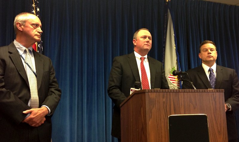 U.S. Attorney Chris Thyer (center) speaks to media Tuesday about the indictments of 16 individuals who are charged with conspiring to distribute cocaine in Arkansas. Standing with Thyer are Randall C. Coleman (right), Special Agent in Charge of the Little Rock Division of the FBI, and Little Rock Police Chief Stuart Thomas (left).