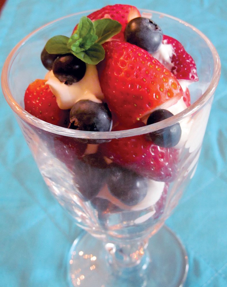 Strawberries and blueberries bathed in balsamic vinegar and a little sweetener are layered with tangy Greek yogurt for a slightly savory and healthy parfait.
