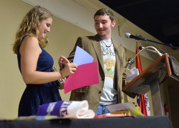 Fayetteville High School seniors Grayce Randolph and A.J. Davis hand out some senior awards Wednesday morning during the Senior breakfast at Mermaids in Fayetteville. The breakfast gave Fayetteville High School seniors a chance to have a little fun together before graduation as they reflected back on their senior year.