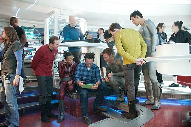 Writer-director J.J. Abrams (seated, with iPad), is surrounded by the crew of the Starship Enterprise on the set of Star Trek Into Darkness. 
