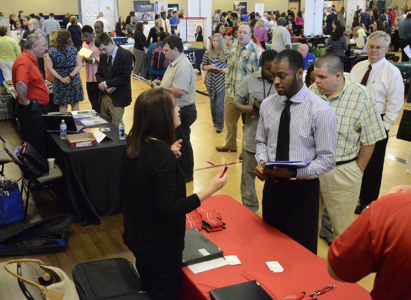 Jennifer Wilhoit of U.S. Express (left) talks with Devin Washington while others wait in line as 63 companies participate in a job fair May 9 at the Brainerd Crossroads in Chattanooga, Tenn. The Labor Department reported Thursday that the number of Americans who applied for unemployment benefits rose 32,000 last week to a seasonally adjusted 360,000, the most since late March. 