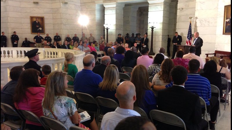 Attorney General Dustin McDaniel speaks to families, officers and patrons at the 32nd annual State Peace Officers' Memorial Service at the State Capitol. The service honored three law enforcement officers killed inthe line of duty this year.