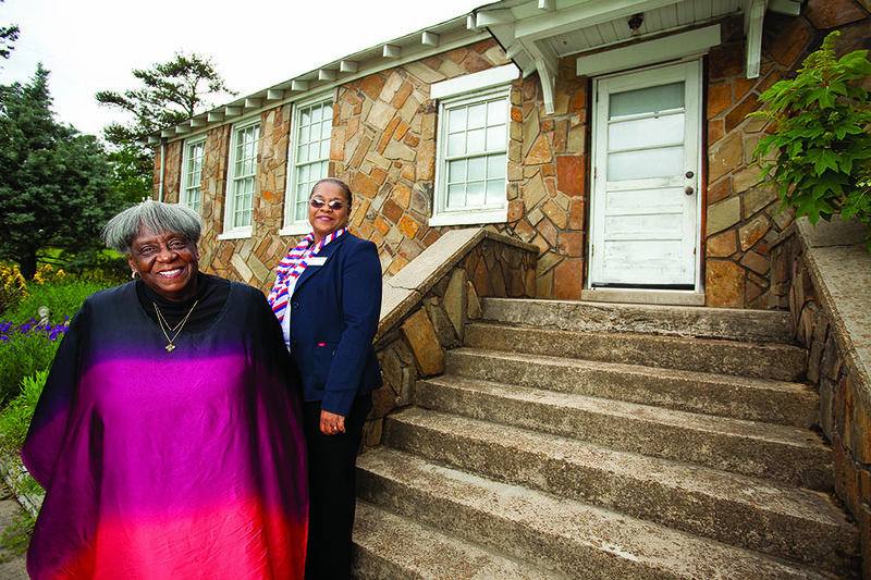 Albessie Thompson, left, and librarian Trudy Smith stand in front of the Twin Groves Library, which will host the Going Back Home celebration Saturday. The event will serve as a reunion for the community and surrounding areas.