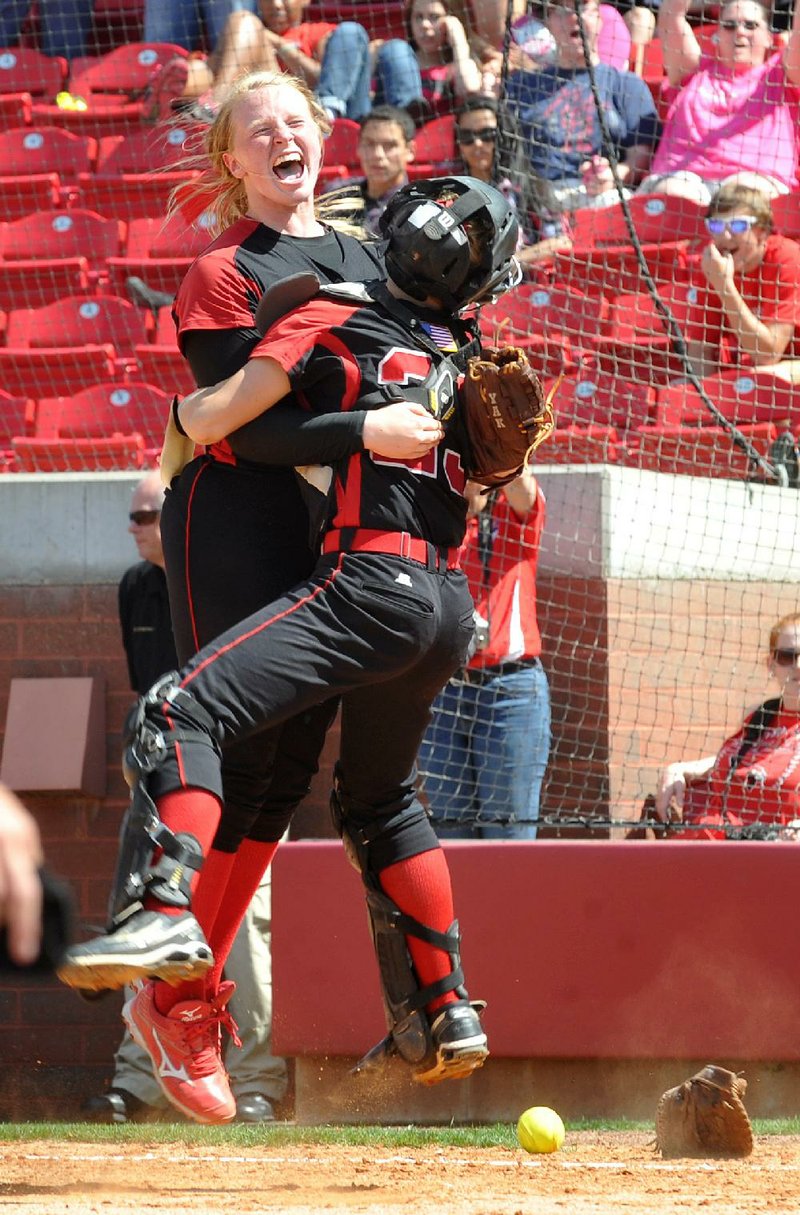 Russellville pitcher Andrea Kindrick (left) and catcher Cortney Norman jump into each other’s arms after the Lady Cyclones defeated Benton in the Class 6A softball championship game. Kindrick struck out 12, allowed 2 hits and did not allow a base runner for 4 innings. 