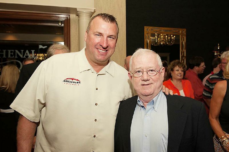 Arkansas football Coach Bret Bielema (left) visits with Arkansas Democrat-Gazette Sports Editor and Arkansas Sports Hall of Fame president Wally Hall during the “Talking Football” dinner Sunday night at Chenal Country Club in Little Rock. 