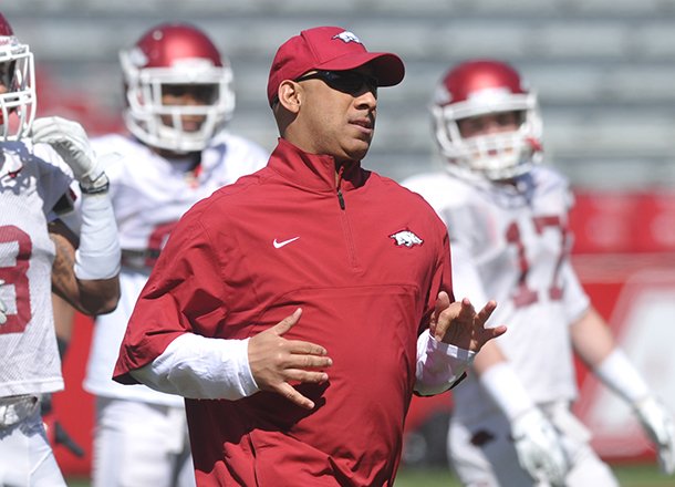 Arkansas Assistant/Wide Receivers Coach coach Michael Smith works with his team during practice Saturday morning at Razorback Stadium in Fayetteville. 
