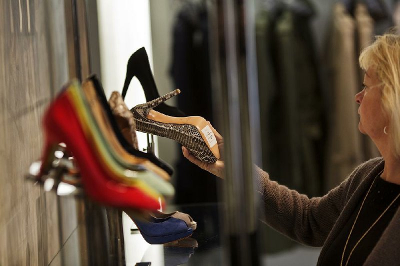 A customer browses shoes at a Coach Inc. store in New York, U.S., on Monday, May 13, 2013. Sales at U.S. retailers unexpectedly advanced in April, helping ease concern of a sustained pullback in consumer spending that would stifle the economy. Photographer: Victor J. Blue/Bloomberg