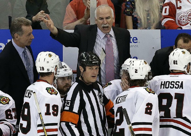 Chicago Blackhawks head coach Joel Quenneville yells at  referee Brad Watson (23) during the third period of an NHL hockey Stanley Cup playoffs Western Conference semifinal game in Detroit, Monday, May 20, 2013. (AP Photo/Paul Sancya)