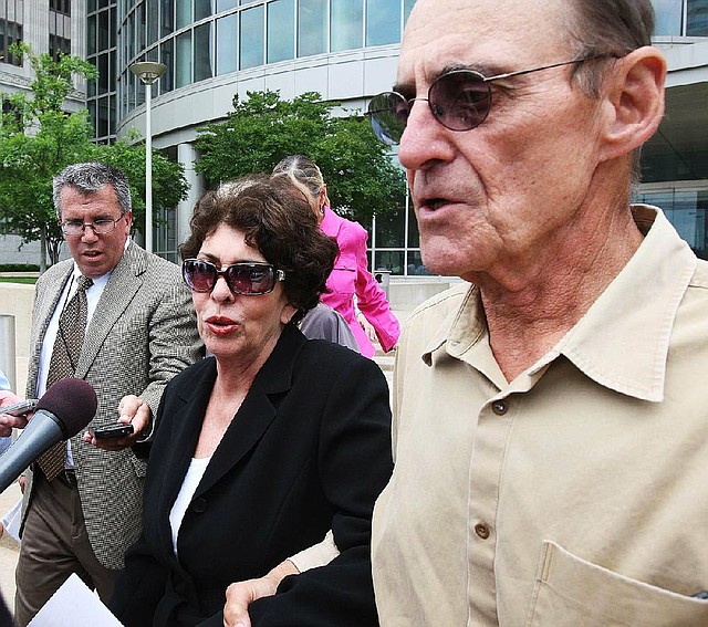  Reporters question Arkansas Treasurer Martha Shoffner as she leaves the federal courthouse Monday afternoon following a hearing on a criminal complaint that charges her under the Hobs act with extortion. 