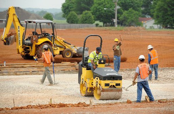 Workers prepare to pour concrete Monday as construction continues on a football stadium at Pea Ridge high school. 