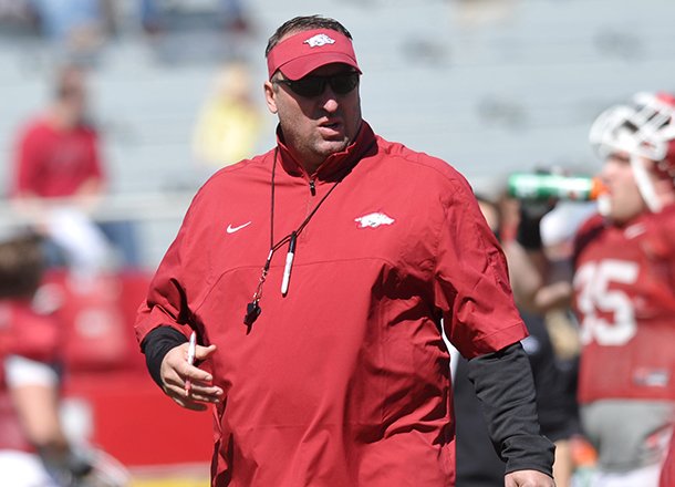 Arkansas coach Bret Bielema watches the Razorbacks warm up during practice April 6, 2013 at Razorback Stadium in Fayetteville. 