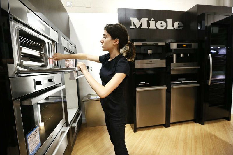 In this photo taken Friday, Apr. 26, 2013, Miele Account Manager Natasha Feldman showcases a Miele steam oven at the Pacific Sales at the Best Buy store in Glendale, Calif. Best Buy Co. Inc. reports quarterly financial results before the market opens on Tuesday, May 21, 2013. (AP Photo/Damian Dovarganes)