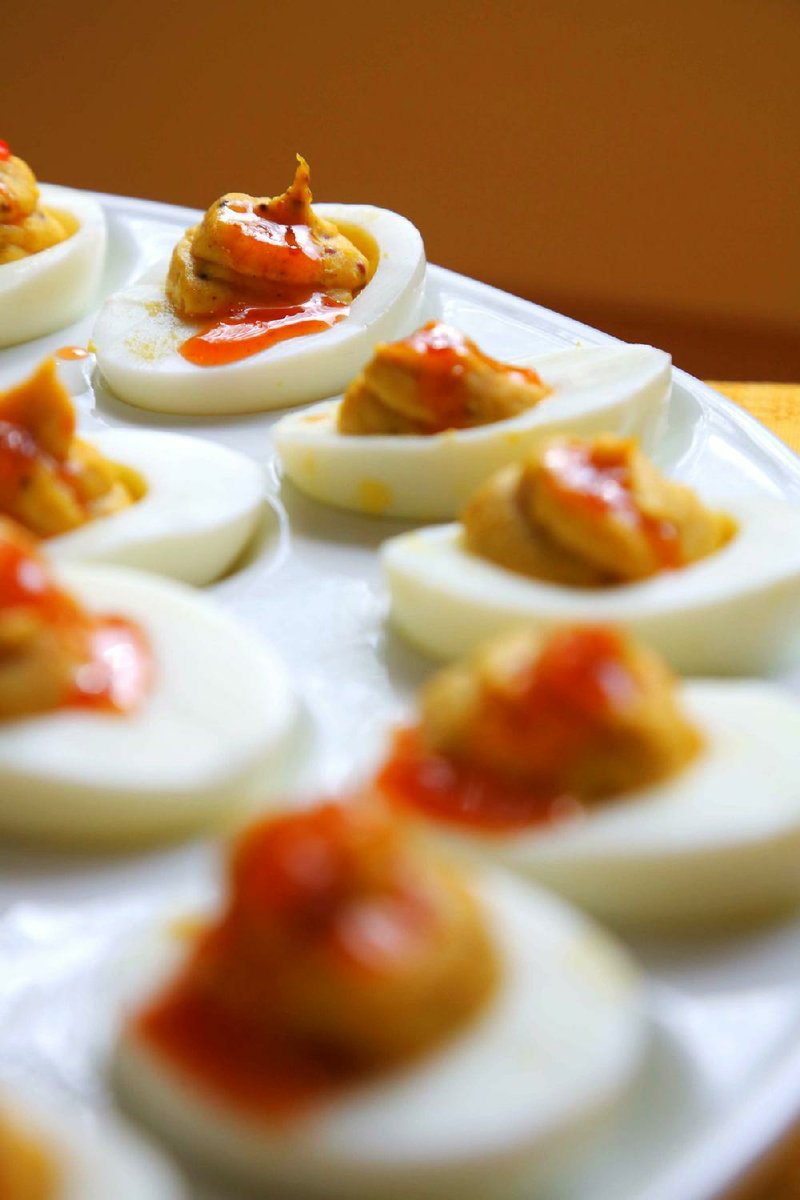 The Devil Made Me Do It deviled eggs (above) combine curry, mustard, fruity hot sauce, garlic and mayonnaise for a tasty twist on the classic potluck favorite. 