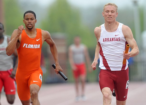 Arkansas runner Marek Niit tries to push in front of Florida's Dedric Dukes as they sprint to the finish line in the mens 4x100 meter relay during the Arkansas Team Invitational on April 27, 2013 at John McDonnell Field in Fayetteville. 