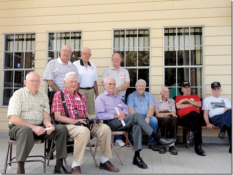 Men gather on the front porch of the Community Hall at last year’s Bauxite reunion. Seated, from the left, are James Smith, Leon Moore, J. Loyd English, Bill Gentry, J.C. Broadway, Larry Cousin and Jack English. Standing, from the left, are Ross Reeves, Dale Mize and Jewell Crowson.