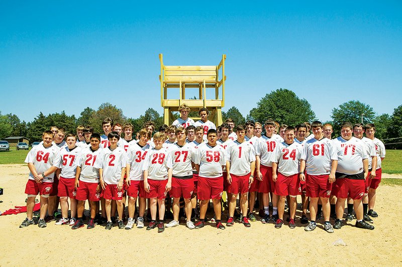 The lifeguard stand at Sandy Beach was recently dedicated in Robert Woods’  honor. Woods, who was a ninth-grader in the Heber Springs Panthers football program, drowned at the beach last year, and that event prompted area residents to achieve the goal of having a lifeguard on duty. Members of the Panthers are shown with the new lifeguard stand.