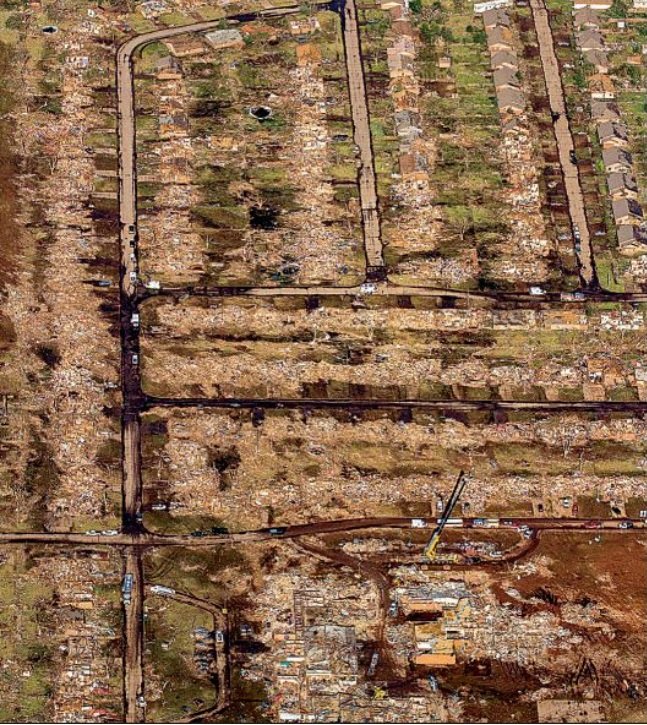 The rubble of Plaza Towers Elementary School can be seen near the crane at the bottom of this aerial photo taken Tuesday over Moore, Okla. 