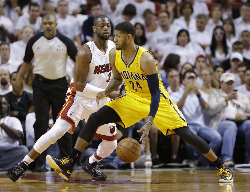 Paul George (right) of the Indiana Pacers hit a three-pointer in the closing seconds to force overtime and made three free throws with 2.2 seconds left to give the Pacers the lead, but LeBron James hit a layup at the buzzer to give the Miami Heat a 103-102 victory in Game 1 of the NBA Eastern Conference finals Wednesday night. 