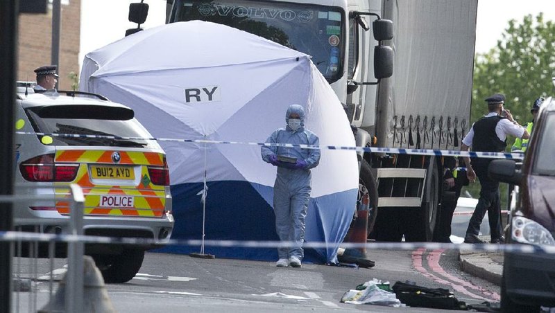 A tent is erected near the scene of Wednesday’s attack in Woolwich southeast London. A British official says a violent attack near a London barracks is being investigated as a possible terrorist act. 