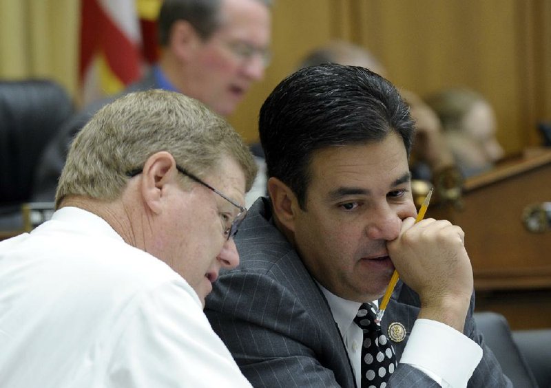 House Judiciary Committee members Rep. Raul Labrador (right), R-Idaho, and Rep. Mark Amodei, R-Nev., talk Wednesday on Capitol Hill in Washington during the committee’s hearing on immigration overhaul. 