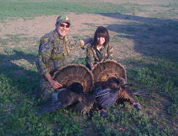 Jim and Elisa Daniel show two Merriam's species of wild turkey they killed in Texas in 2011 when Elisa was 14. 