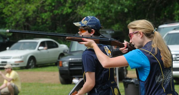 Natalie Akers with the Shiloh Christian School trap shooting team fires at a flying clay target during practice on Saturday near Hogeye. Fifty-eight students from sixth grade through high school make up the shooting team. 