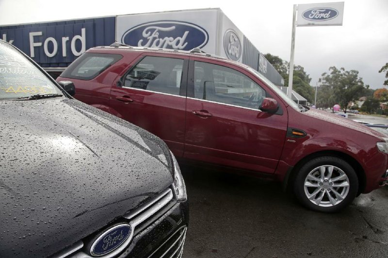 New cars sit on a Ford dealership lot in Sydney. Ford said Thursday that it will stop making cars in Australia, closing two assembly plants. 