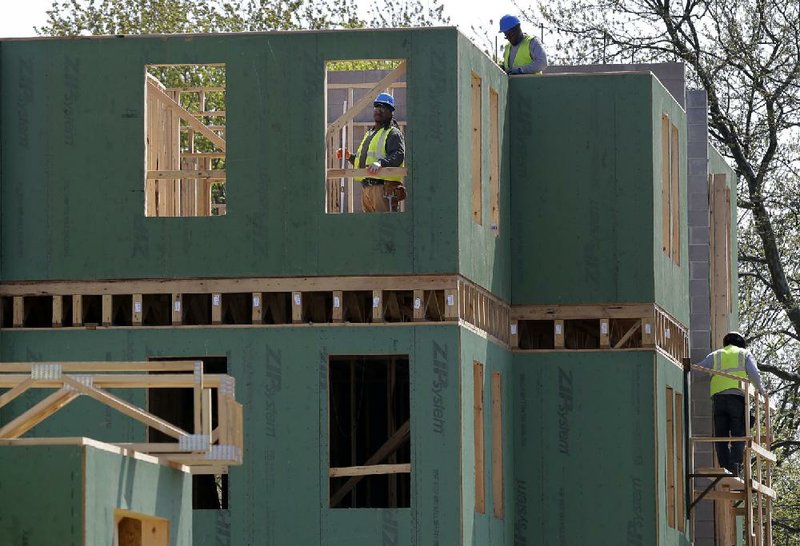 A construction crew works on the frame of a new house in Trenton, N.J., in April. Sales of new homes rose 2.3 percent in April, the Commerce Department said Thursday. 