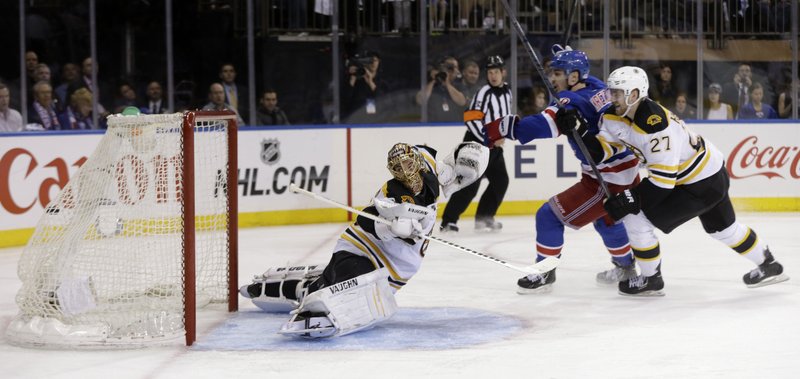 New York Rangers forward Chris Kreider (center) scores the winning goal past Boston Bruins goalie Tuukka Rask (left) and Dougie Hamilton during the overtime period of Thursday’s game in New York. The Rangers won 4-3 to stay alive in the Eastern Conference finals. Boston leads the series 3-1. 