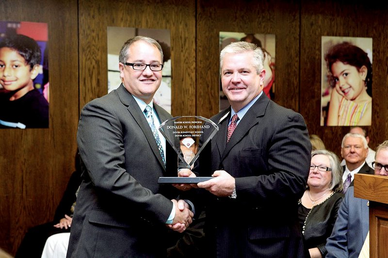 Donny Forehand, principal of Dover Elementary School, left, receives his Master School Principal Certification plaque from Arkansas Commissioner of Education Tom Kimbrell at the Arkansas Department of Education meeting in Little Rock on May 13. Forehand earned the certification through the Arkansas Leadership Academy.