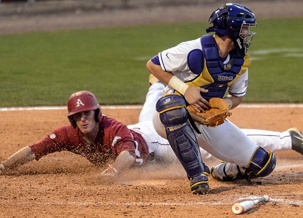 Arkansas runner Matt Vinson, left, slides safely into home as LSU's Ty Ross takes the throw in the eighth inning of their Southeastern Conference Tournament NCAA college baseball game at the Hoover Met in Hoover, Ala., Thursday, May 23, 2013. (AP Photo/Dave Martin)