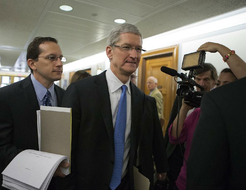 Apple CEO Tim Cook arrives on Capitol Hill, in Washington, Tuesday, May 21, 2013, to testify before the Senate Homeland Security and Governmental Affairs Permanent subcommittee on Investigations hearing to examine the methods employed by multinational corporations to shift profits offshore and how such activities are affected by the Internal Revenue Code.  Cook is expected to defend how the world's most valuable company, based in Cupertino, Calif., holds a billion dollars in an Irish subsidiary as a tax strategy, according to a report issued this week by the subcommittee.  (AP Photo/J. Scott Applewhite)