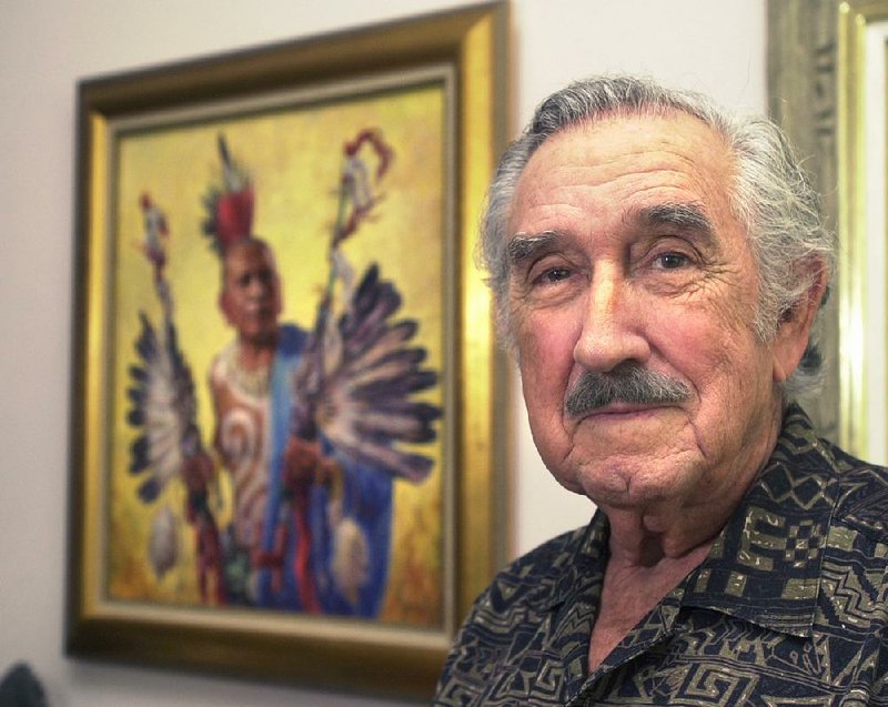 Charles Banks Wilson stands near his painting of the Quapaw. The photo was taken in his Fayetteville home in 2003. 