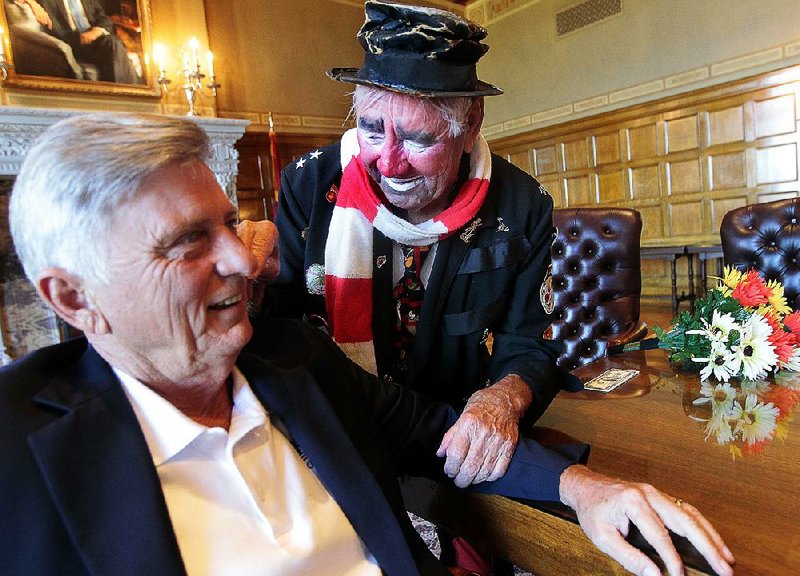 Gov. Mike Beebe reacts with fear, horror and revulsion when confronted last year by a clown lobbying to be included in Riverfest. 