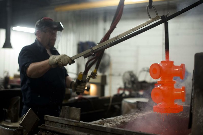 An employee at Hartzell Propeller Inc.’s manufacturing plant in Piqua, Ohio, pulls propeller clamps from a kiln where they were tempered on Tuesday. Orders for durable goods, those expected to last at least three years, rose 3.3 percent last month. 