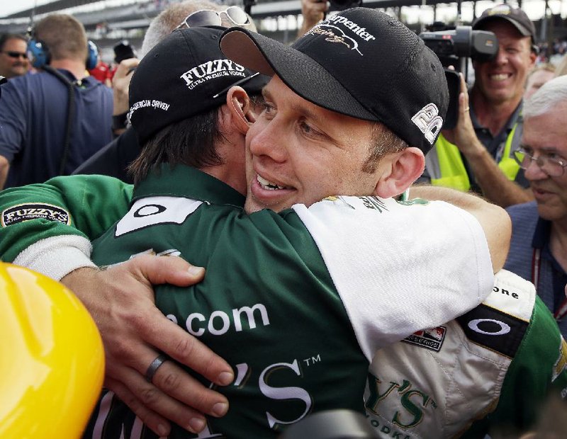 Ed Carpenter (right) hugs a team member after winning the pole for the 97th running of the Indianapolis 500 on Sunday at Indianapolis Motor Speedway. Carpenter will try to hold off 2012 winner Dario Franchitti and Helio Castroneves, both of whom will be going for a fourth victory. 
