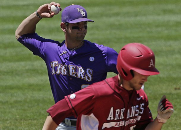 LSU's Aaron Nola, rear, throws out Arkansas' Joe Serrano on a sacrifice bunt in the sixth inning of their Southeastern Conference Tournament baseball game at the Hoover Met in Hoover, Ala., Saturday, May 25, 2013. (AP Photo/Dave Martin)