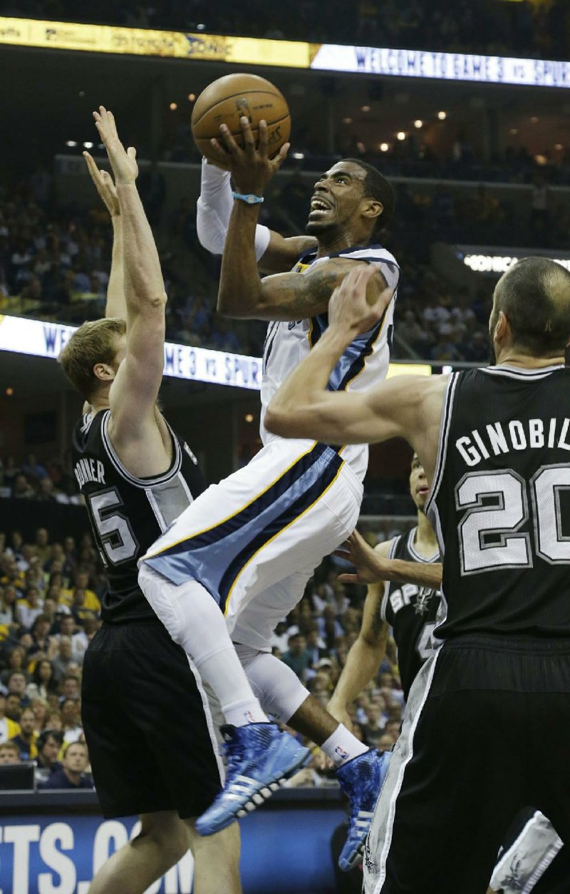 Memphis Grizzlies' Mike Conley, center, drives to the basket as San Antonio Spurs guard Manu Ginobili (20) and forward Matt Bonner (15) defend during the first half in Game 3 of the Western Conference finals NBA basketball playoff series in Memphis, Tenn., Saturday, May 25, 2013. (AP Photo/Danny Johnston)