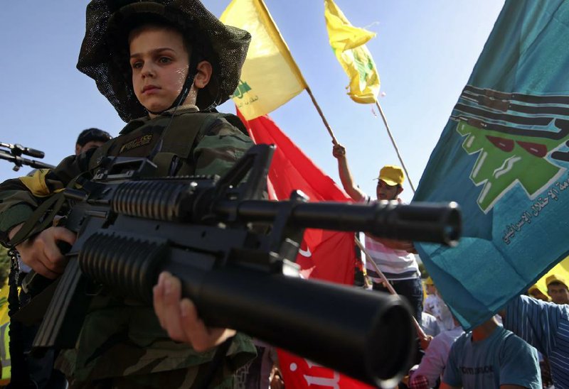 A Lebanese boy dressed up like a soldier attends a rally Saturday in Mashghara, Lebanon, marking Israel’s withdrawal from southern Lebanon in 2000. Hezbollah leader Sheikh Hassan Nasrallah used the occasion to underscore his fighters’ support for Syria. 