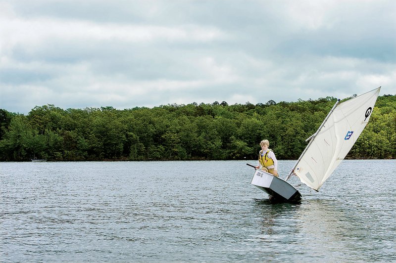 Logan Meyer, who learned his skills in youth classes given by the Grande Maumelle Sailing Club, maneuvers a roll tack, a way of causing his boat to change directions rapidly, during the club’s April 28 regatta on Lake Maumelle. 