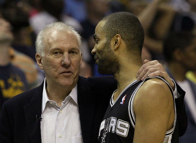 San Antonio Spurs head coach  Gregg Popovich, left,  talks to San Antonio Spurs guard Tony Parker, of France, during a timeout in the first half of Game 4 of the Western Conference finals NBA basketball playoff series against the Memphis Grizzlies, in Memphis, Tenn., Monday, May 27, 2013. (AP Photo/Danny Johnston)