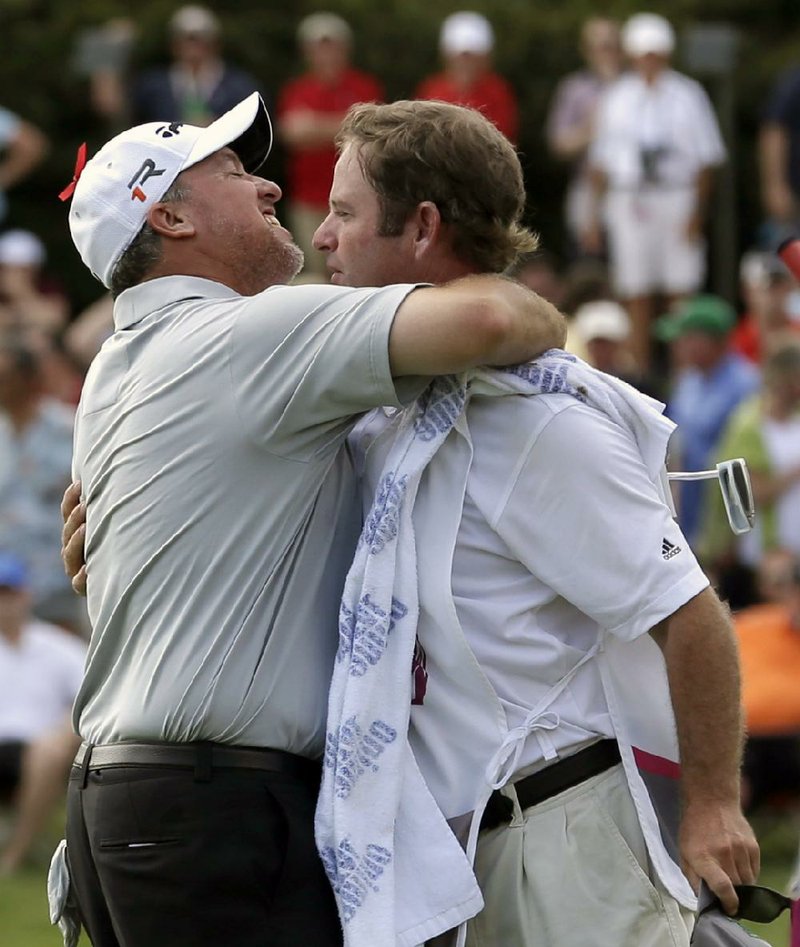 Boo Weekley (left) celebrates a one-stroke victory Sunday over Matt Kuchar in the Crowne Plaza Invitational with a hug from caddy Barry Williams at the Colonial Country Club in Fort Worth. 