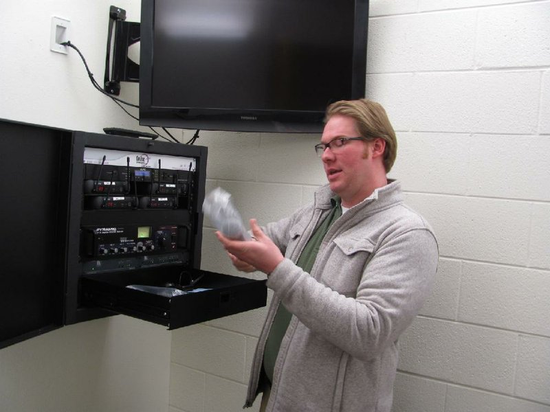 ine1

Arkansas Democrat-Gazette/DAVE HUGHES

Sebastian County Juvenile Detention Center teacher Beau Pumphrey unwraps a microphone at the control panel for a video teaching aid system in the center’s new classroom area. The system will allow inmates that must be physically separated to interact during learning sessions.