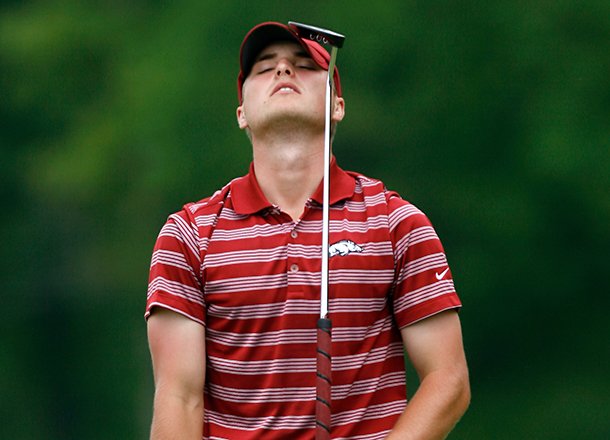 Arkansas senior Austin Cook reacts after missing a putt on the 18th green during the final round of the NCAA men's golf regional on Saturday, May 18, 2013, at The Blessings Golf Club in Fayetteville.