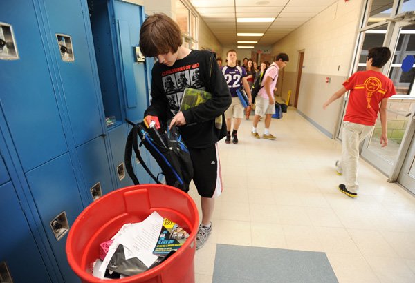 Logan Black, 15, a freshman at Woodland Junior High School in Fayetteville, cleans out his locker Friday as the final week of school approaches. The last day of school for most schools in the Fayetteville School District is Friday. 