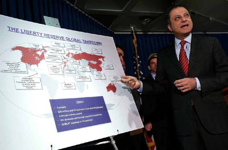 Preet Bharara, U.S. Attorney for the Southern District of New York, describes a chart showing the global interests of Liberty Reserve, during a news conference in New York, Tuesday, May 28, 2013. Arthur Budovsky,the founder of Liberty Reserve, was indicted in the United States along with six other people in a $6 billion money-laundering scheme described as "staggering" in its scope, authorities said Tuesday.(AP Photo/Richard Drew)