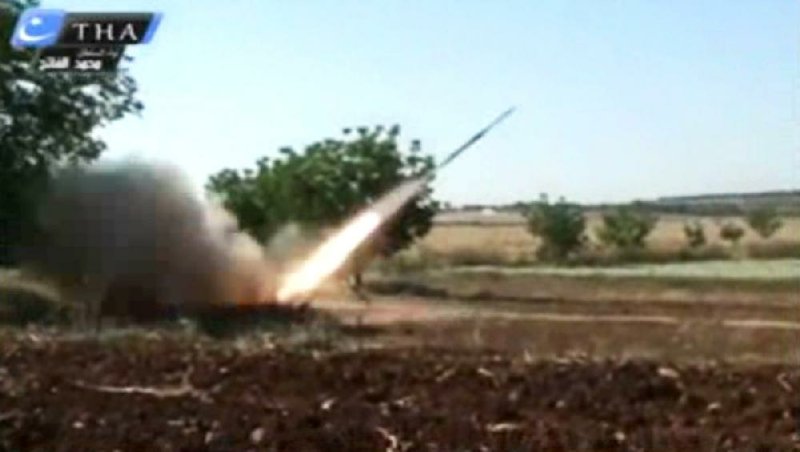 This image from amateur video obtained by a group which calls itself Ugarit News, which is consistent with AP reporting, shows a rocket fired by Syrian rebels in Qusair, Syria, Tuesday, May 28, 2013. Europe's decision to allow member states to arm Syrian rebels and Russia's renewed pledge to send advanced missiles to the Syria regime could spur an arms race in an already brutal civil war and increasingly turn it into a East-West proxy fight. Britain promises not to transfer any arms before diplomacy is given a chance in Syria peace talks expected next month, while a top rebel commander says he needs Western anti-aircraft and anti-tank missiles now to prevent more regime gains on the battlefield. (AP Photo/Ugarit News via AP video)