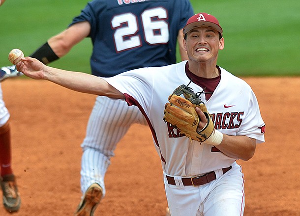 Arkansas second baseman Jordan Farris tags out Ole Miss baserunner Stuart Turner as he completes a double play to first base in the sixth inning of a May 22, 2013 game in Hoover, Ala. 