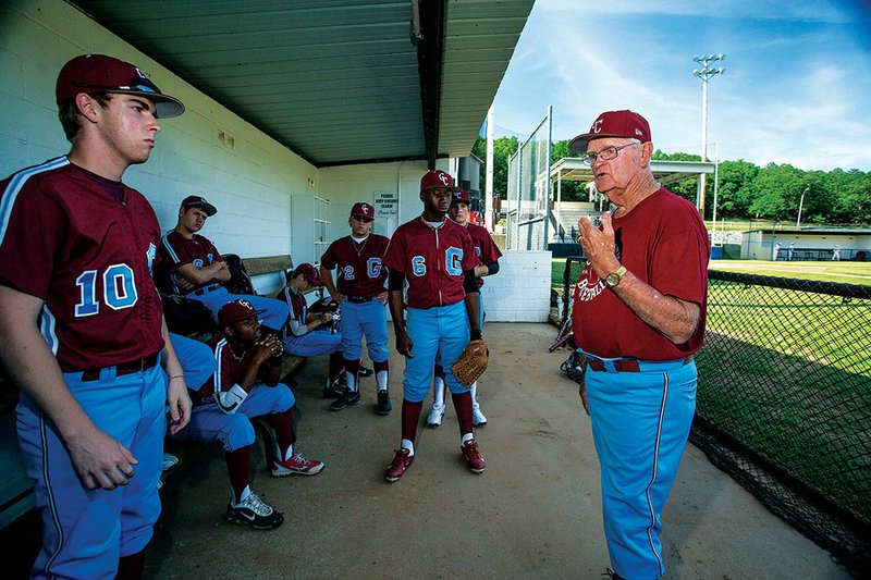 Bob Hickingbotham, right, who coaches the Gwatney Chevrolet American Legion baseball teams in Jacksonville, gives instruction to Josh Cook, left, and other players before the teams’ first games of the season.