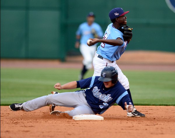 Orlando Calixte of the Northwest Arkansas Naturals turns to throw to first for a double play after forcing out Corpus Christi Hooks’ Enrique Hernandez on Tuesday at Arvest Ballpark in Springdale. 